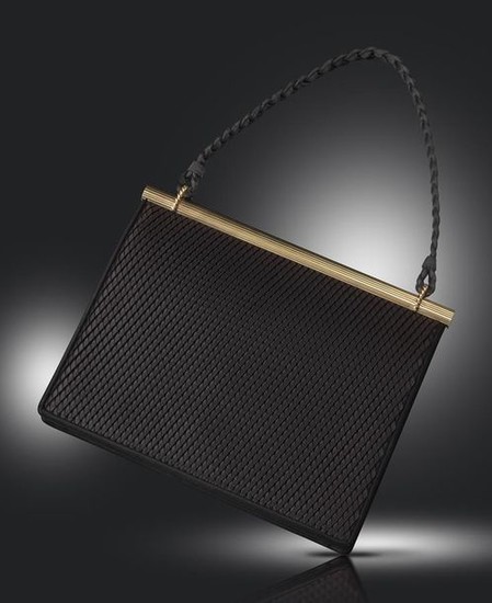 A silk and gold evening bag by Cartier,...