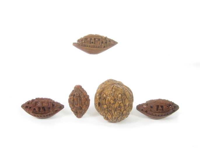 A small collection of carved peach stones and walnut shells