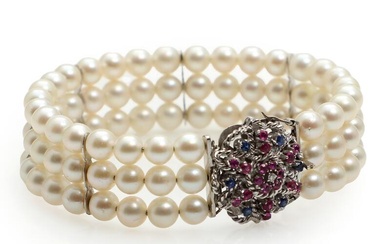 A three strand pearl bracelet set with numerous cultured pearls, mounted with...