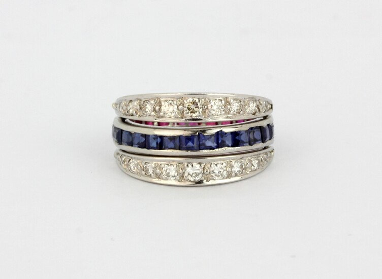 A white metal (tested 18ct gold) metamorphic ring set with square cut rubies and sapphires and brilliant cut diamonds, (O).