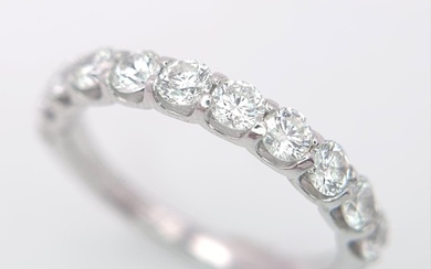 An 18 K white gold half eternity ring with good quality bril...