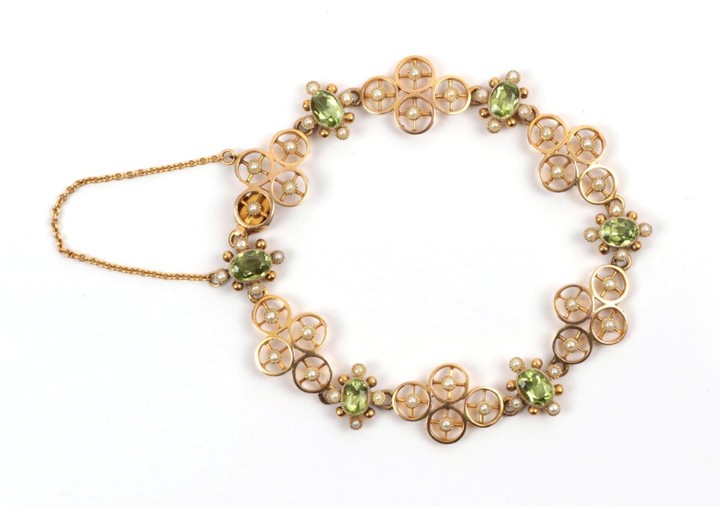 An Early 20th Century Peridot and Seed Pearl Bracelet, quatrefoil...
