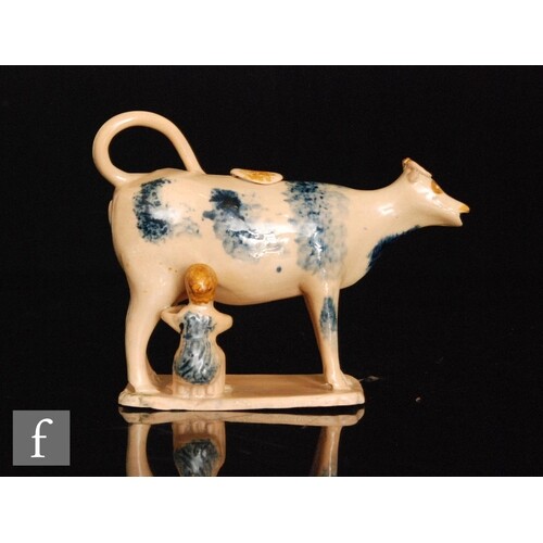 An early 19th Century cow creamer and cover with milk maid a...