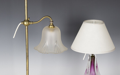 An early 20th century brass adjustable student's lamp with frosted glass shade and weighted bas