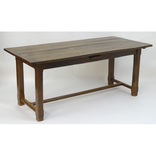 An early 20thC oak refectory / dining table with a large rec...