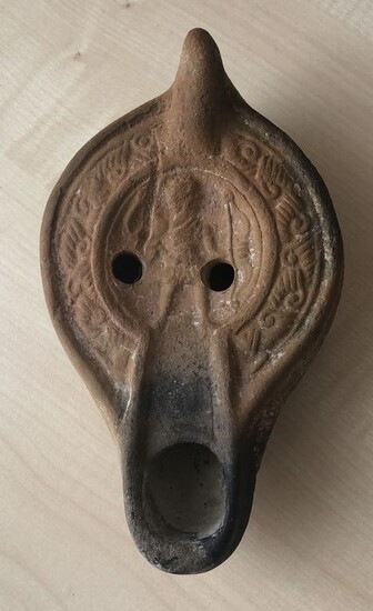 Ancient Roman Terracotta Discus lamp with a long snout and handle. Diana in the mirror