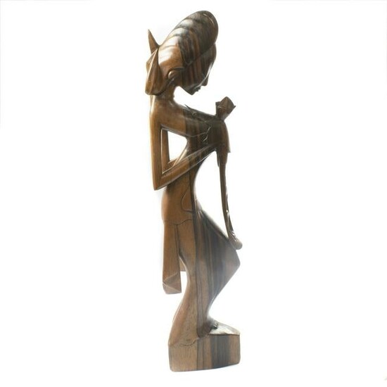 Balinese wood sculpture of a lady holding a flower
