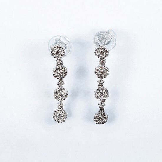 Beautiful long white gold earrings, cascading rosettes set with...