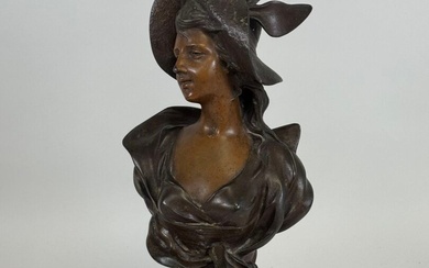 Georges COUDRAY (1862-1932), d'après. Buste de femme. Sujet en régule, le socle en marbre rouge....