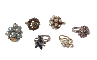 Group of six 1960s/1970s gold and multi-gem set cocktail rings to include a sapphire and diamond cluster ring, a turquoise and ruby cluster ring, three cultured pearl cluster rings and a white ston...