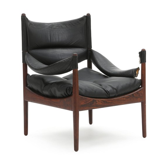 Kristian S. Vedel: “Modus”. An easy chair with rosewood frame. Loose cushions upholstered with patinated black leather.