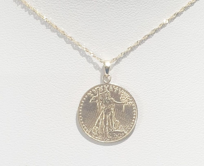 Lady Liberty portrait coin necklace and pendant And behind the famous new 14K yellow gold eagle....