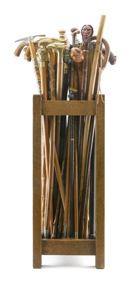 MISSION OAK STAND CONTAINING APPROX. SIXTY-FIVE ASSORTED CANES Stand stamped 432511 on underside. Canes include a Dartmouth College...