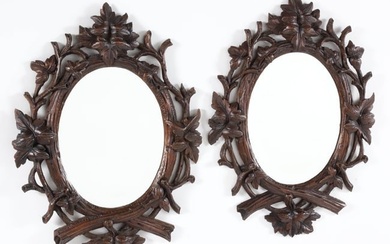 Pair of Antique Black Forest Carved Oak Leaf and Branch Oval Mirrors