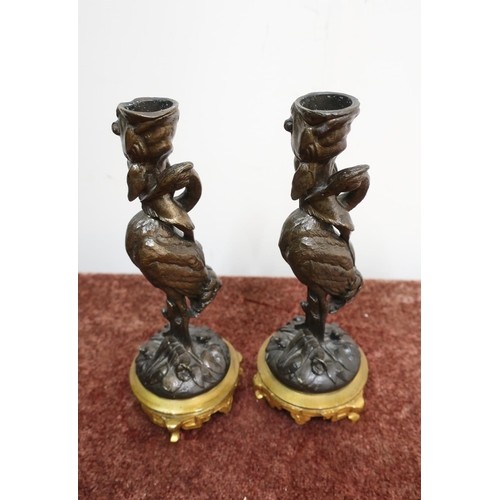 Pair of bronze candlesticks in the form of storks, with gild...
