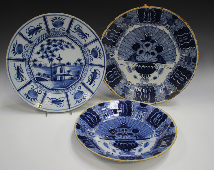 Three Dutch Delft chargers, mid to late 18th century, comprising one painted with a chinoiserie land
