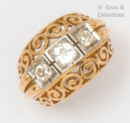 Yellow gold and platinum "Dôme" ring with openwork volutes holding three old-cut diamonds. Finger size: 57. Rough weight: 12.7g.