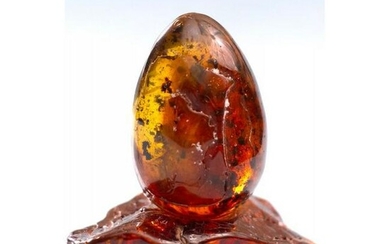 19.68 g. Natural Amber egg on a stand hand carved from