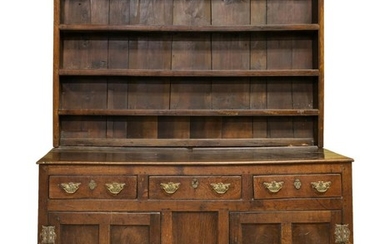 ENGLISH TWO-PART STEP-BACK CUPBOARD In oak. Upper case with molded cornice and three shelves. Lower case with three drawers over two...