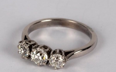 A diamond three-stone ring, claw set in precious white