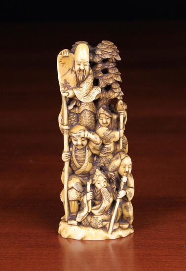 A 19th Century Carved Walrus Tusk Okimono depicting The Seven Gods of Luck & Good Fortune climbing a