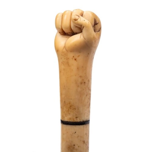 A 19th century marine ivory walking cane with carved pommel ...