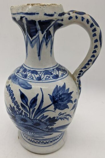 A 19th century or earlier Delft blue and white jug with
