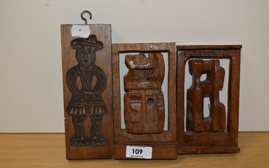 A 20th Century hand carved wooden butter mould with figural design, measuring 20cm tall, and two