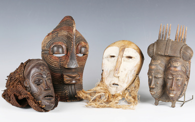 A Baule carved wooden twin mask, Ivory Coast, finely modelled and painted with two faces with woven