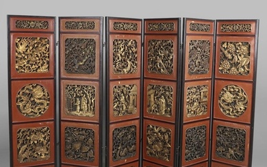 A CHINESE CARVED AND LACQUERED SIX FOLD SCREEN. early 20th c...