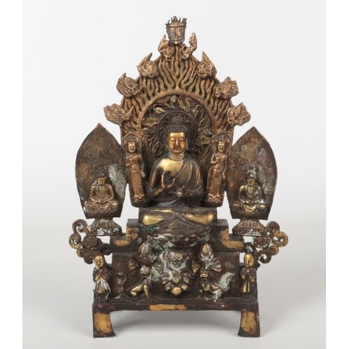 A Chinese bronze Buddhistic devotional group. Raised on a st...
