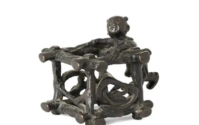 A Chinese bronze paperweight Ming dynasty In the form of a boy...