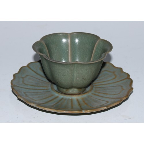 A Chinese celadon lotus wine cup and stand, the saucer 14cm ...