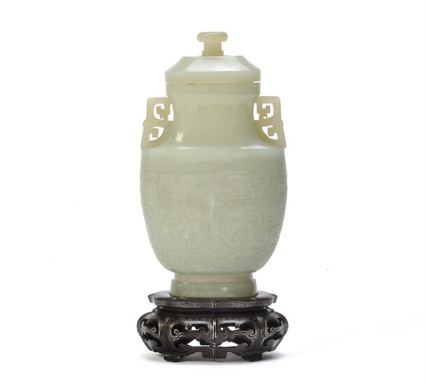 A Chinese pale celadon jade archaistic vase and cover