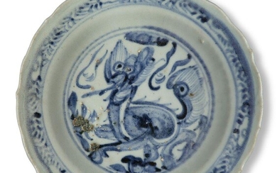 A Chinese porcelain blue and white barbed 'kylin' dish, Ming dynasty, 15th century, on short foot below a moulded ribbed band rising to a barbed rim, the interior painted with a kylin surrounded by a band of leaves and ruyi heads, 20cm diameter