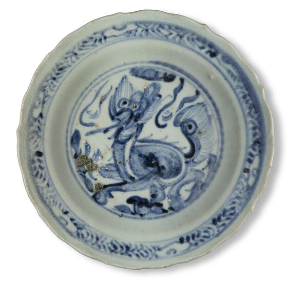 A Chinese porcelain blue and white barbed 'kylin' dish, Ming dynasty, 15th century, on short foot below a moulded ribbed band rising to a barbed rim, the interior painted with a kylin surrounded by a band of leaves and ruyi heads, 20cm diameter