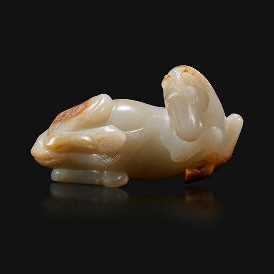 A Chinese russet and greyish-white carved jade figure