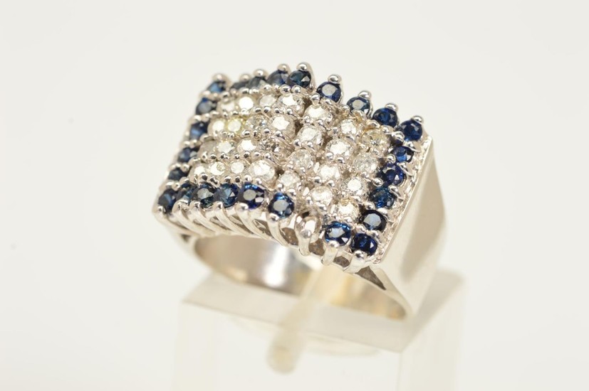 A DIAMOND AND SAPPHIRE RING, a tiered rectangular panel set ...