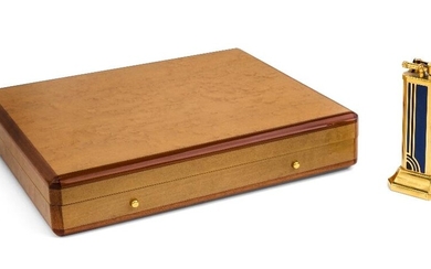 A Dunhill birds eye maple humidor, modern, the cedar lined box with applied Dunhill Made in France label, 5cm high, 25cm wide, 22cm deep; together with a Dunhill brass table lighter, with blue and black enamel decoration, stamped Dunhill and Made...