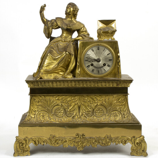 A French gilt bronze statue clock, the seated female examining a necklace