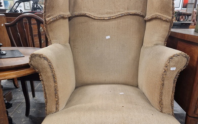 A GEORGE III MAHOGANY WING BACK ARMCHAIR, THE CABRIOLE FRONT LEGS ON PAW FEET