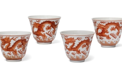 A GROUP OF FOUR IRON-RED DECORATED 'DRAGON' CUPS, TWO CUPS, TONGZHI SIX-CHARACTER MARKS IN UNDERGLAZE BLUE AND OF THE PERIOD (1862-1874) THE OTHER TWO CUPS, GUANGXU SIX-CHARACTER MARKS IN UNDERGLAZE BLUE AND OF THE PERIOD (1875-1908)