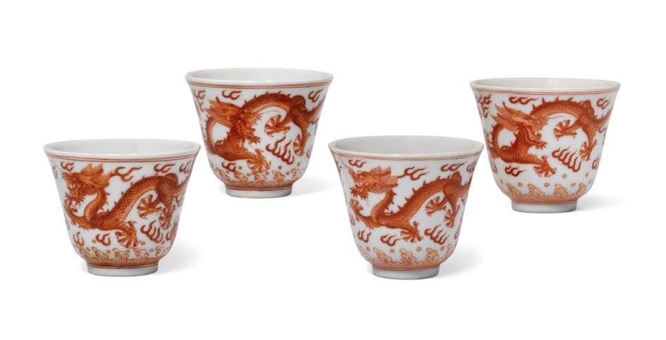 A GROUP OF FOUR IRON-RED DECORATED 'DRAGON' CUPS, TWO CUPS, TONGZHI SIX-CHARACTER MARKS IN UNDERGLAZE BLUE AND OF THE PERIOD (1862-1874) THE OTHER TWO CUPS, GUANGXU SIX-CHARACTER MARKS IN UNDERGLAZE BLUE AND OF THE PERIOD (1875-1908)