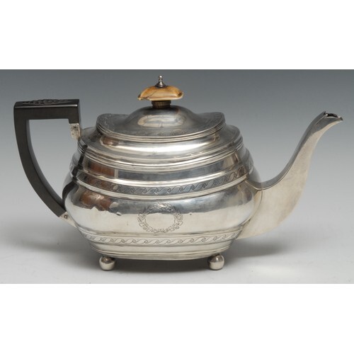 A George III silver boat shaped teapot, bright-cut engraved ...