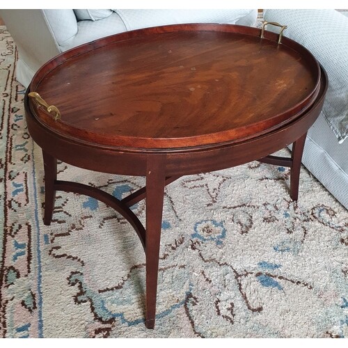 A Georgian Mahogany oval Butlers Table with gallery topped t...