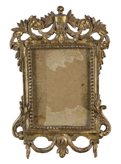 A Glazed Florentine Carved, Pierced and Gilded Frame, late 17th / early 18th century, with beaded sight, plain hollow and top taenia, the top with scrolling and crested leaf and flower head flanking a centred urn, lower side foliate scrollwork and...