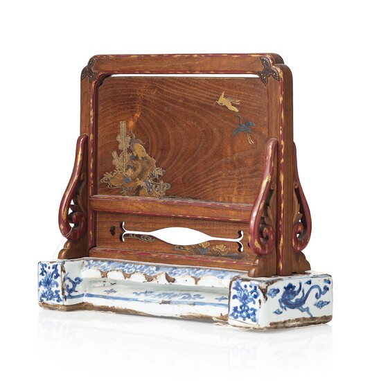 A Japanese wooden and lacquered table screen on a blue and white Ming dynasty porcelain base.