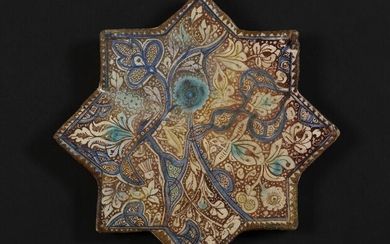 SOLD. A Kashan star shaped pottery tile decorated in lustre, blue and turquoise with flowers and design. Iran, 13th century. H. 20.5 cm. – Bruun Rasmussen Auctioneers of Fine Art