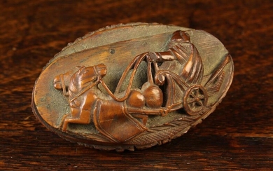 A Late 18th Century Carved Coquilla Nut Snuff Box. The oval lid carved in relief with a man riding h