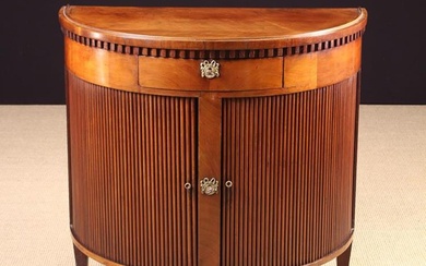 A Mahogany Demi-lune Side Cabinet with tambour front doors below a central frieze drawer, standing o